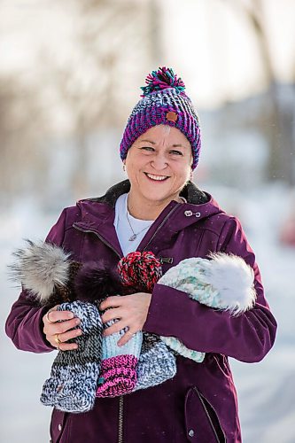 MIKAELA MACKENZIE / WINNIPEG FREE PRESS

Kyla Simms poses for a portrait with her toques in Winnipeg on Tuesday, Jan. 18, 2022. She is an armed forces veteran who has ptsd and, as therapy, was taught how to use a type of loom to make toques. She has since made so many she was able to give some to fellow patients and nurses at the health care facility in Ontario she was at and has recently donated 50 of them to Lighthouse Mission. For Kevin story.
Winnipeg Free Press 2022.