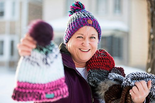 MIKAELA MACKENZIE / WINNIPEG FREE PRESS

Kyla Simms poses for a portrait with her toques in Winnipeg on Tuesday, Jan. 18, 2022. She is an armed forces veteran who has ptsd and, as therapy, was taught how to use a type of loom to make toques. She has since made so many she was able to give some to fellow patients and nurses at the health care facility in Ontario she was at and has recently donated 50 of them to Lighthouse Mission. For Kevin story.
Winnipeg Free Press 2022.