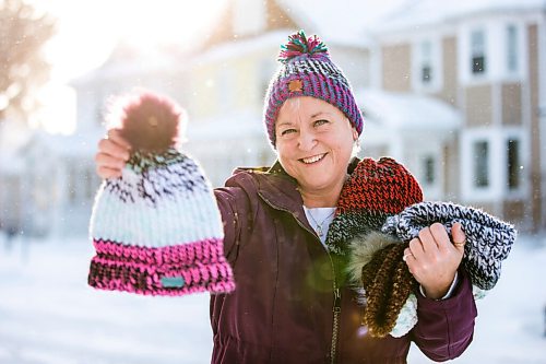 MIKAELA MACKENZIE / WINNIPEG FREE PRESS

Kyla Simms poses for a portrait with her toques in Winnipeg on Tuesday, Jan. 18, 2022. She is an armed forces veteran who has ptsd and, as therapy, was taught how to use a type of loom to make toques. She has since made so many she was able to give some to fellow patients and nurses at the health care facility in Ontario she was at and has recently donated 50 of them to Lighthouse Mission. For Kevin story.
Winnipeg Free Press 2022.