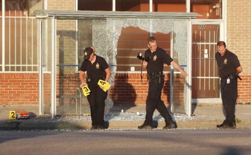BORIS.MINKEVICH@FREEPRESS.MB.CA  100704 BORIS MINKEVICH / WINNIPEG FREE PRESS A person was shot at a bus shelter on Main Street near Stella. The suspect is in custody. Taken to hospital in critical. Here Ident unit members asses the scene.