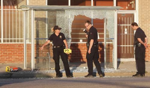 BORIS.MINKEVICH@FREEPRESS.MB.CA  100704 BORIS MINKEVICH / WINNIPEG FREE PRESS A person was shot at a bus shelter on Main Street near Stella. The suspect is in custody. Taken to hospital in critical. Here Ident unit members asses the scene.