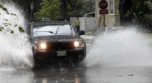 BORIS.MINKEVICH@FREEPRESS.MB.CA  100705 BORIS MINKEVICH / WINNIPEG FREE PRESS Cars splash through the water on Wolseley near Arlington.