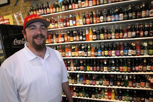 BORIS.MINKEVICH@FREEPRESS.MB.CA  100705 BORIS MINKEVICH / WINNIPEG FREE PRESS Tyler Frego of Dingo's Wild & Crazy Dogs with his stock of cool bottled drinks.