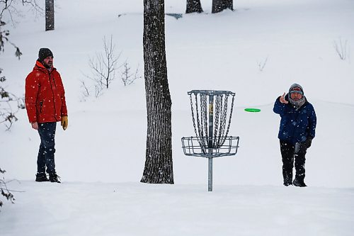 JOHN WOODS / WINNIPEG FREE PRESS
Jason The, right, owner of Disc Republic, retailer for all things disc sport related, putts as his friend Kevin Talgoy looks on at Happyland Park disc golf course, Sunday, January 23, 2022. 

Re: standup