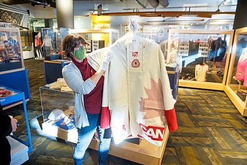 MIKE DEAL / WINNIPEG FREE PRESS
Andrea Reichert, curator at the Manitoba Sports Hall of Fame & Museum, with artifacts from previous winter Olympics.
A jacket worn by an athlete to the 2006 Winter Olympics.
See Brenda Suderman story
220125 - Tuesday, January 25, 2022.