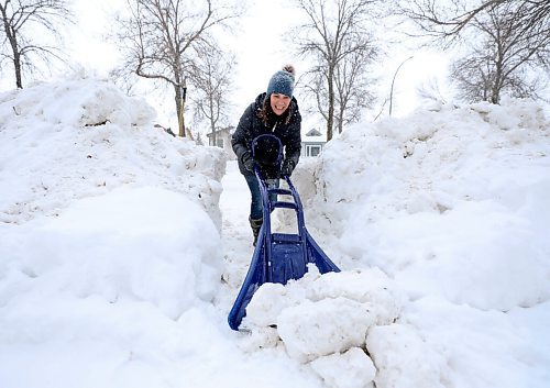 RUTH BONNEVILLE / WINNIPEG FREE PRESS

Local - Standup shovelling out a pathway.

Cindy Bennett celebrates hitting the bottom of a 5 ft high mound of snow blocking an entranceway from the street to her front walkway on Wednesday.  She says she's cleared it at least 4 times this winter for her mom to be able to access her front door from the street.  

Jan 26th,  2022