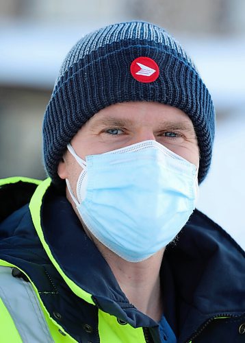 RUTH BONNEVILLE / WINNIPEG FREE PRESS

Local - letter carrier 

Letter-carrier Corey Gallagher was sent home from his work at Canada Post because his boss said he couldnt wear a medical grade respirator, similar to an N95, to work.

Gallagher wears a white 95PFE-L3 with a  blue provided "Level 2" mask on top in photo. 

Jan 28th,  2022