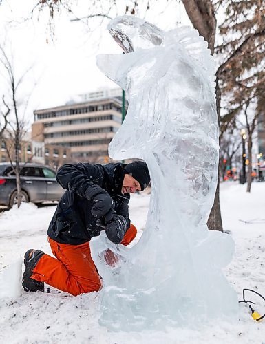 Daniel Crump / Winnipeg Free Press. Daniel Friesen and Helen Friesen carve a goldeye out of a block of ice on Broadway near Gary Street. The ice is sourced from the Red River and the project is part of an exhibit called Winter Wanderland, a joint venture between Downtown Winnipeg BIZ and Sputnik Architecture. January 29, 2022.