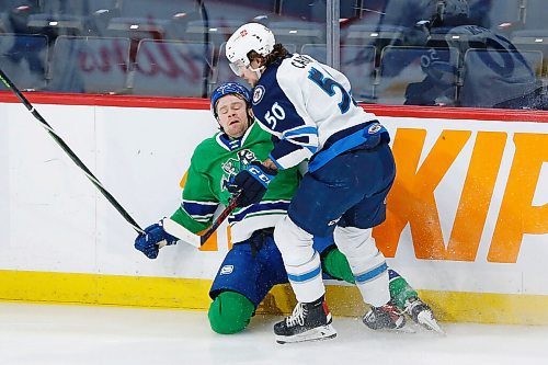 JOHN WOODS / WINNIPEG FREE PRESS
Manitoba Moose Thomas Caron (50) checks Abbotsford Canucks Matt Murphy (77) during first period AHL action in Winnipeg on Sunday, January 30, 2022.

Reporter: Allen