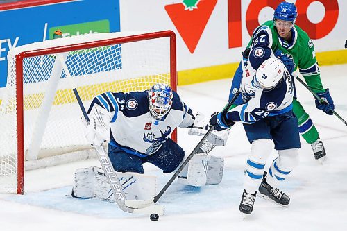 JOHN WOODS / WINNIPEG FREE PRESS
Manitoba Moose goaltender Arvid Holm (35) looks on as Ty Pelton-Byce (29) clears the rebound in front of the Abbotsford Canucks John Stevens (16) during first period AHL action in Winnipeg on Sunday, January 30, 2022.

Reporter: Allen