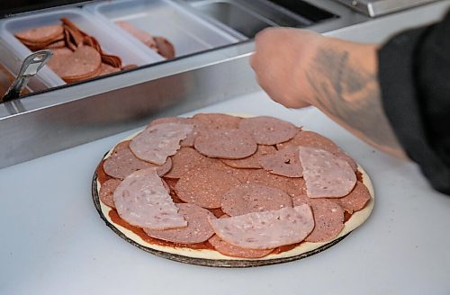 JESSICA LEE / WINNIPEG FREE PRESS

Jack Colombe, co-owner of Thompson-Style Pizza, makes a Shane Special on January 28, 2022, named for Colombes brother who took his own life three years ago.

Reporter: Dave




