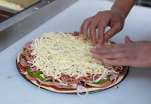 JESSICA LEE / WINNIPEG FREE PRESS

Jack Colombe, co-owner of Thompson-Style Pizza, makes a Shane Special on January 28, 2022, named for Colombes brother who took his own life three years ago.

Reporter: Dave




