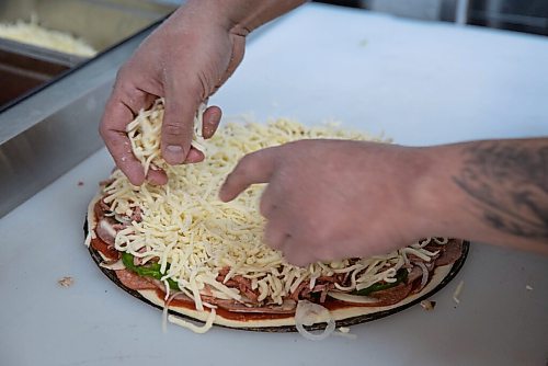 JESSICA LEE / WINNIPEG FREE PRESS

Jack Colombe, co-owner of Thompson-Style Pizza, makes a Shane Special on January 28, 2022, named for Colombes brother who took his own life three years ago.

Reporter: Dave




