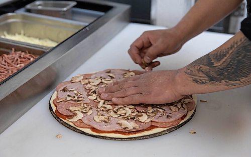 JESSICA LEE / WINNIPEG FREE PRESS

Jack Colombe, co-owner of Thompson-Style Pizza, makes a Shane Special on January 28, 2022, named for Colombes brother who took his own life three years ago.

Reporter: Dave




