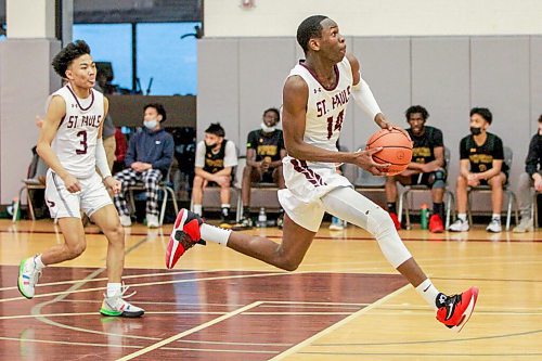 MIKAELA MACKENZIE / WINNIPEG FREE PRESS

St. Pauls Crusader Ramogi Nyagudi (14) plays in a game against the John Taylor Pipers in Winnipeg on Monday, Jan. 31, 2022.  For Mike Sawatzky story.
Winnipeg Free Press 2022.