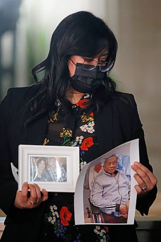 JOHN WOODS / WINNIPEG FREE PRESS
Melissa Carter holds family photos after she spoke about her elderly father at a press conference at the Manitoba Legislature, Monday, January 31, 2022. Mr. Apalit was transferred from Concordia Hospital to Minnedosa.

Re: Danielle