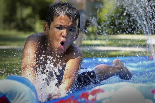MIKE.DEAL@FREEPRESS.MB.CA 100709 - Friday, July 09, 2010 -  WEA feature Christopher Ouellette, 10, stays cool on a slip 'n slide in a friends front yard in River Heights.  MIKE DEAL / WINNIPEG FREE PRESS