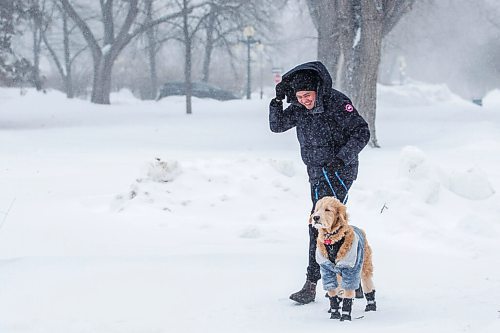 MIKAELA MACKENZIE / WINNIPEG FREE PRESS

Joel Deal Torre and his dog, Nylo, battle the blowing snow while walking on the legislative grounds in Winnipeg on Tuesday, Feb. 1, 2022.  Standup.
Winnipeg Free Press 2022.