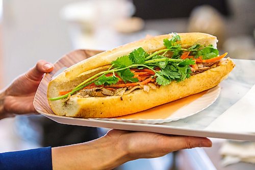 MIKAELA MACKENZIE / WINNIPEG FREE PRESS

Hang Pham holds up a BBQ pork bahn mi at the newly opened Banh Mi Mr. Lee in Winnipeg on Tuesday, Feb. 1, 2022. For Ben Waldman story.
Winnipeg Free Press 2022.