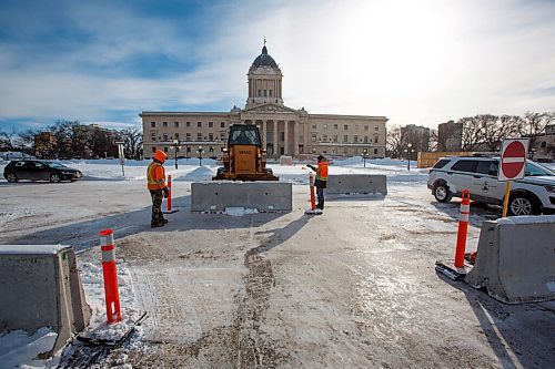 MIKE DEAL / WINNIPEG FREE PRESS
A front-end loader pushes concrete barriers into position in anticipation of the "trucker" protest Friday morning at the Manitoba Legislative building.
220203 - Thursday, February 03, 2022.