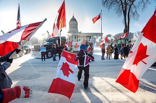 MIKE DEAL / WINNIPEG FREE PRESS
Annie Wiebe waves an upside-down Canadian flag at supporters as they drive by on Broadway during the Anti-Vaccine Mandate protest Friday morning.
Protesters block the entrance to the Manitoba Legislative building on Broadway and have parked their trucks along Memorial early Friday morning.
220204 - Friday, February 04, 2022.