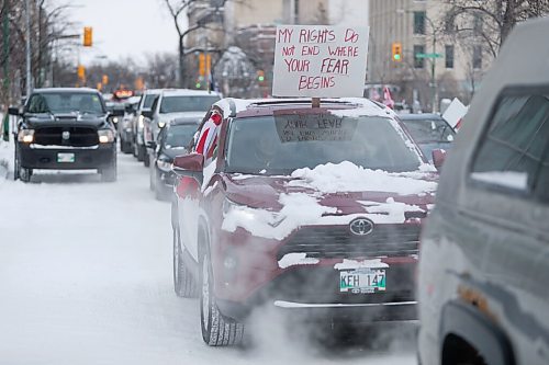 Daniel Crump / Winnipeg Free Press. People waves signs and honk their horns as the trucker convoy protest at the Manitoba legislature continues Saturday in Winnipeg. February 5, 2022.