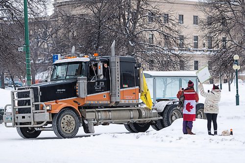 Daniel Crump / Winnipeg Free Press. protestors and a counter protestor interact as the trucker convoy protest at the Manitoba legislature continues Saturday in Winnipeg. February 5, 2022.