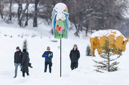 Daniel Crump / Winnipeg Free Press. People walk by a windsock on the Nestaweya river trail on the Assiniboine river Saturday afternoon. The windsock is an art installation titled Come Fly with Me and is part of a collection of nine different pieces that has been installed on the trail. February 5, 2022.