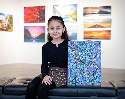 JESSICA LEE / WINNIPEG FREE PRESS

Nehal Safi, 7, is photographed at Cre8ery Gallery supporting her father artist Tameem Safis show Through and Through on February 8, 2022. She holds a painting she made with help from her father.

Reporter: Ben




