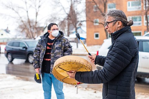 MIKAELA MACKENZIE / WINNIPEG FREE PRESS

George Spence sings and honour song as Davey Cole listens at the warming fire at Sunshine House in Winnipeg on Tuesday, Feb. 8, 2022. For Eva Wasney story.
Winnipeg Free Press 2022.