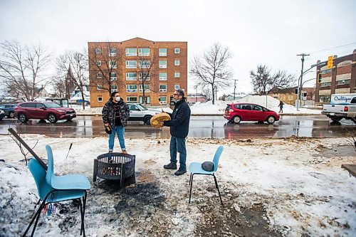 MIKAELA MACKENZIE / WINNIPEG FREE PRESS

George Spence sings and honour song as Davey Cole listens at the warming fire at Sunshine House in Winnipeg on Tuesday, Feb. 8, 2022. For Eva Wasney story.
Winnipeg Free Press 2022.