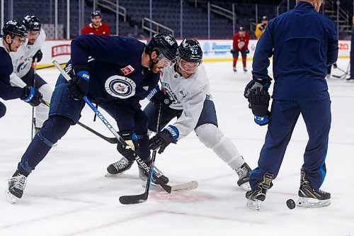 MIKE DEAL / WINNIPEG FREE PRESS
Winnipeg Jets' Paul Stastny (25) and Adam Lowry (17) face off during practice at Canada Life Centre Thursday morning.
220210 - Thursday, February 10, 2022.