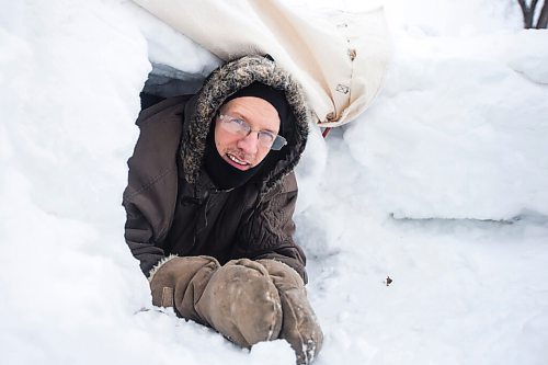 MIKAELA MACKENZIE / WINNIPEG FREE PRESS

Alex Wiebe, who loves embracing the winter elements, poses for a portrait in his backyard quinzhee in Winnipeg on Thursday, Feb. 10, 2022. . For Declan story.
Winnipeg Free Press 2022.