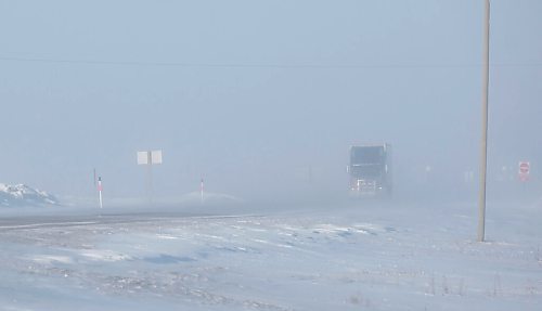MIKE DEAL / WINNIPEG FREE PRESS
Vehicles emerge from the blowing snow on the Trans-Canada Highway early Friday morning. 
220211 - Friday, February 11, 2022.