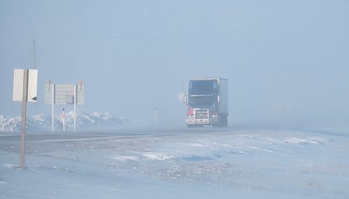 MIKE DEAL / WINNIPEG FREE PRESS
Vehicles emerge from the blowing snow on the Trans-Canada Highway early Friday morning. 
220211 - Friday, February 11, 2022.
