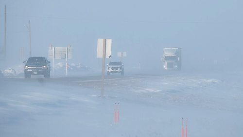 MIKE DEAL / WINNIPEG FREE PRESS
Vehicles emerge from the blowing snow on the Trans-Canada Highway early Friday morning. 
220211 - Friday, February 11, 2022.
