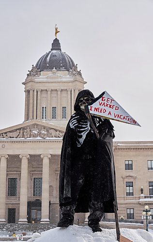 David Lipnowski / Winnipeg Free Press

A counter protester dressed as the grim reaper stands across the street from the downtown freedom rally Saturday February 12, 2022.