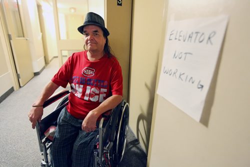 Brandon Sun 17072010 Third Floor tenant Russ Criddle is seen outside the out-of-order elevator at the Westman Kiwanis Court apartment building in Brandon on Saturday. The broken elevator is making it difficult for some tenants to get to or from their apartments. (Tim Smith/Brandon Sun)