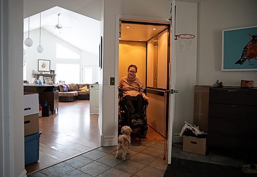 JESSICA LEE / WINNIPEG FREE PRESS

Yvette Cenerini, a digital collage maker and a wheelchair user, is photographed using the elevator at her home on February 15, 2022 while her dog Jasper greets her.

Reporter: Eva
