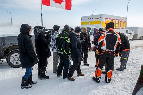 MIKE DEAL / WINNIPEG FREE PRESS
Protesters stand infant of a camera person while a reporter tries to talk to a trucker blocking the border crossing at Emerson, MB.
220216 - Wednesday, February 16, 2022.