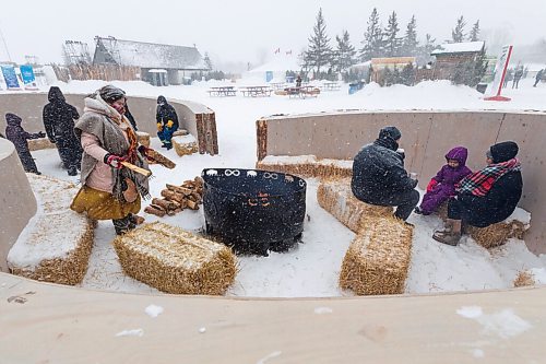 Daniel Crump / Winnipeg Free Press. People sit and warm up at the new Infinity Fire at Festival du Voyageur in Winnipeg. The Festival returns for the first time since prior to the pandemic. February 19, 2022.