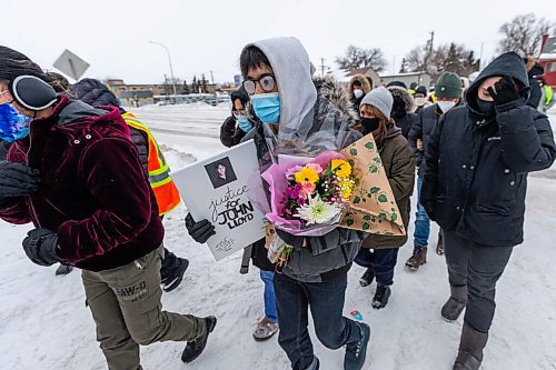 Daniel Crump / Winnipeg Free Press. Family and friends lead the vigil as they ceremonial walk John Lloyd Barrion home one last time across Notre Dame Ave. Well over a hundred people attend a vigil to honour John Lloyd Barrion, 19, who was killed while working at the beer vendor attached to the Travelodge on Notre Dame Ave. February 19, 2022.