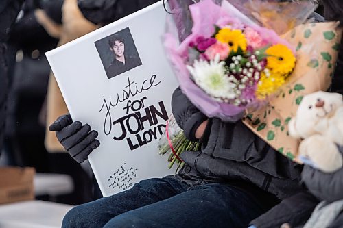 Daniel Crump / Winnipeg Free Press. Members of John Lloyd Barrions family sit at the front of a vigil in his honour. Barrion was killed while working at the beer vendor attached to the Travelodge on Notre Dame Ave. February 19, 2022.