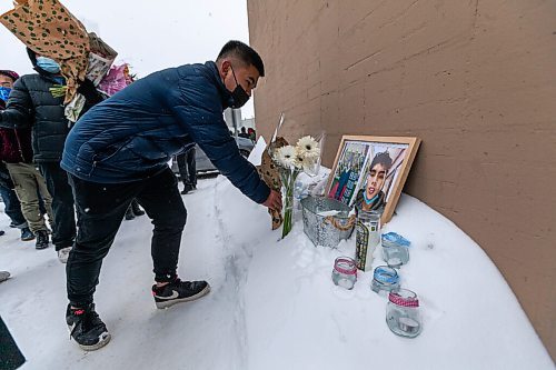 Daniel Crump / Winnipeg Free Press. People place candles and flowers near the pick up window where John Lloyd Barrion worked. Barrion was killed while working at the beer vendor attached to the Travelodge on Notre Dame Ave. February 19, 2022.