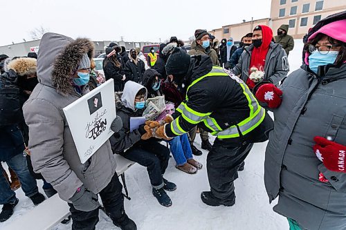 Daniel Crump / Winnipeg Free Press. Community members give their condolences to the family of John Lloyd Barrion. Well over a hundred people attend a vigil to honour Barrion, who was killed while working at the beer vendor attached to the Travelodge on Notre Dame Ave. February 19, 2022.