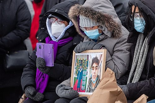 Daniel Crump / Winnipeg Free Press. Members of John Lloyd Barrions family sit at the front of a vigil in his honour. Barrion was killed while working at the beer vendor attached to the Travelodge on Notre Dame Ave. February 19, 2022.