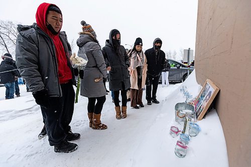 Daniel Crump / Winnipeg Free Press. People place candles and flowers near the pick up window where John Lloyd Barrion worked. Barrion was killed while working at the beer vendor attached to the Travelodge on Notre Dame Ave. February 19, 2022.