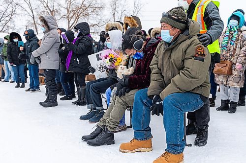 Daniel Crump / Winnipeg Free Press. Members of John Lloyd Barrions family sit at the front of a vigil in his honour. Barrion was killed while working at the beer vendor attached to the Travelodge on Notre Dame Ave. February 19, 2022.