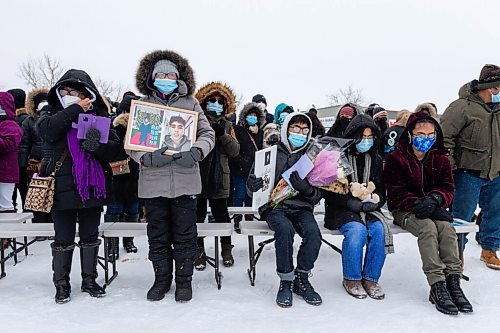 Daniel Crump / Winnipeg Free Press. Members of John Lloyd Barrions family sit at the front of a vigil in his honour. Barrion was killed while working at the beer vendor attached to the Travelodge on Notre Dame Ave. February 19, 2022.