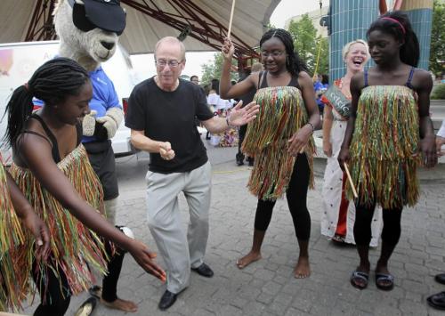 MIKE.DEAL@FREEPRESS.MB.CA 100722 - Thursday, July 22, 2010 -  Sam Katz mayor of Winnipeg gets an impromptu dance lesson from members of the Ghanian Union of Manitoba Cultural Dance Group while at the official launch of Folklorama at The Forks.  MIKE DEAL / WINNIPEG FREE PRESS
